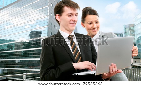 Business people working together against the backdrop of a modern office center