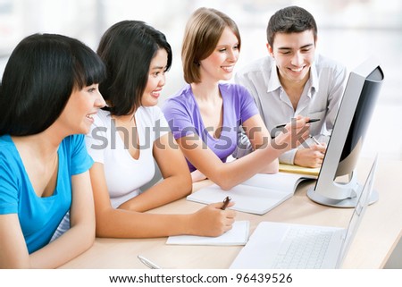 Young female students working together in classroom