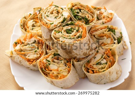 Tortilla rolled into a roulade stuffed with chicken and Korean carrot