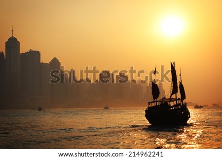 Chinese junk ship sailing towards sunset