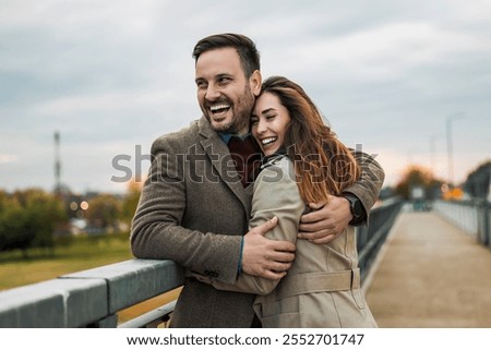 Similar – Image, Stock Photo Couple embracing on bridge under arch with flowers