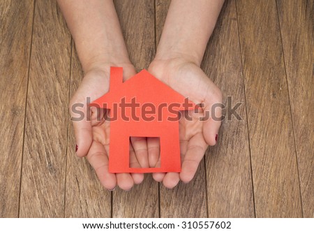 Man with small house in his hands