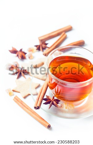 Delicious tea with spices in a glass cup isolated on white