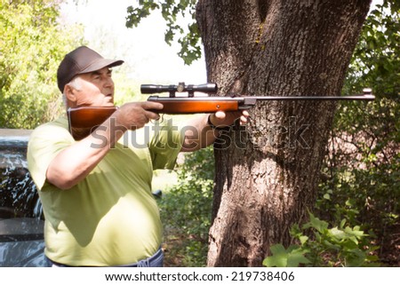 Grandfather with rifle. Elderly man. Hunting. Guns in hands