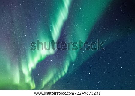 Night starry sky and Northern lights. Green aurora borealis