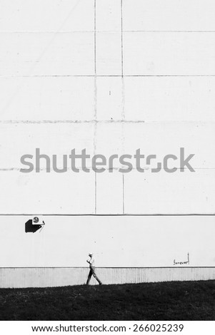 Walking man. Man goes against wall. Employee goes to work. City scene. Black and white photo