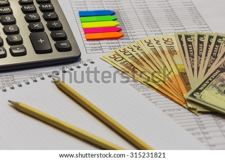 Note pad with pen, calculator and cash