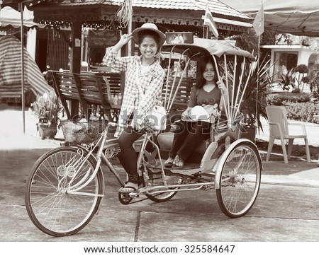 Tricycle bicycle taxi for local people and tourists on April 13, 2015 in Nan,Thailand. Tricycle bicycle taxi is one of the public and old transport in Thailand.