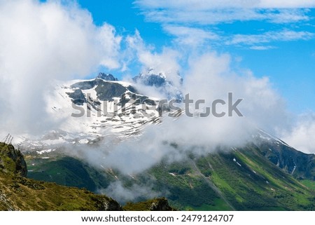 Similar – Foto Bild Schroffer Berggipfel eingehüllt in dunkle Wolken