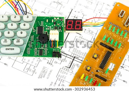 Workbench for alarm and inter-phone electronics repair, electronic diagram, multimeter, electronic components, electronic board, screwdrivers, transistors, integrated circuits, capacitors, LED