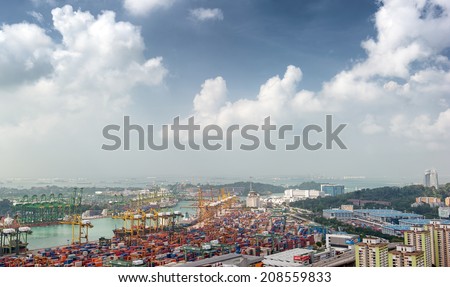 SINGAPORE - 2 JAN, 2014: Commercial port of Singapore. Bird eye panoramic view of busiest Asian cargo port with hundreds of ships loading export and import goods and thousands of containers in harbor