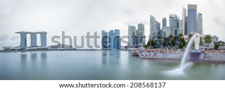 SINGAPORE - 1 JAN, 2014: Marina Bay central business district in Singapore. Day time city skyline panorama. Marina Bay Sands and Merlion statue are famous landmarks of the country
