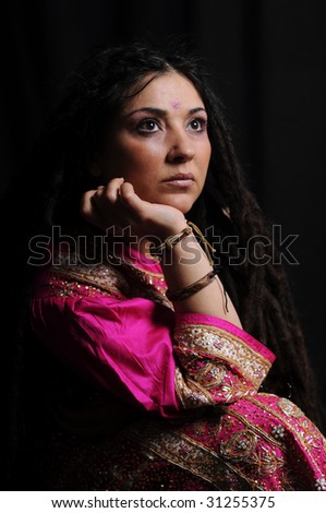 A beautiful Indian woman wearing a traditional sari