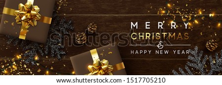 Merry Christmas and Happy New Year. Brown background from wooden boards, snowflakes with glitter sparkle, realistic pine cones, holiday gift boxes. Xmas garlands and gold confetti, presents box