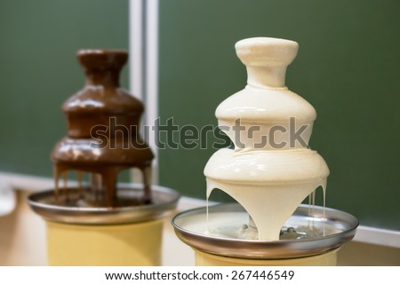 Two chocolate white and dark fondue fountains on school party