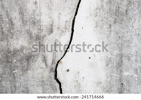 Old dirty cement wall broken apart left a long crack on the wall