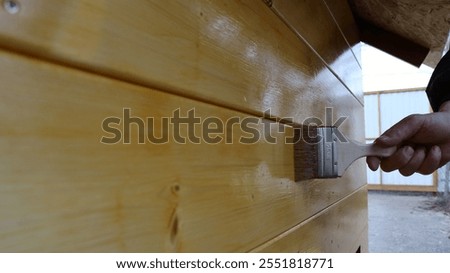 Similar – Image, Stock Photo Craftsman applying varnish to wood jalousie using airbrush in carpentry workshop