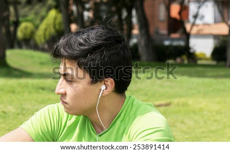 Young man at a local park taking a break and thinking about workout