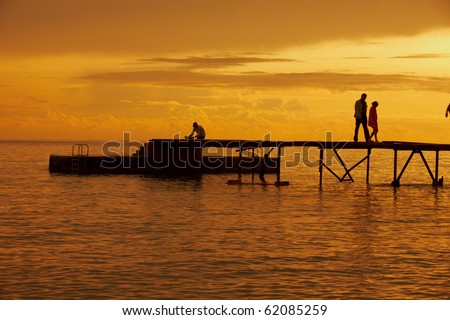 Sunset over pier in town\'s beach in Montenegro southeast Europe