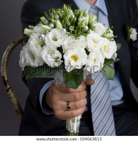 Man holding out a wedding bouquet