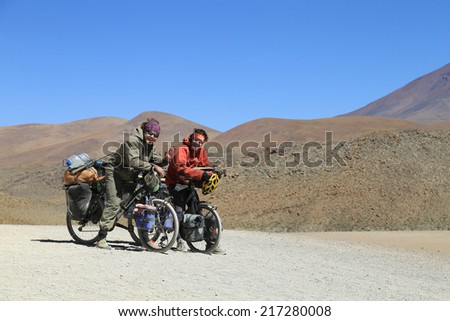 Salar de Uyuni desert, Bolivia - April, 11 2014 :  Tourists riding mountain bike in Salar de Uyuni desert of Bolivia which is the largest salt flat in the world.