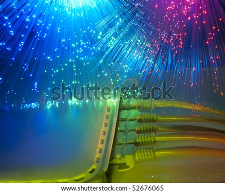 network cable and hub closeup with fiber optical background