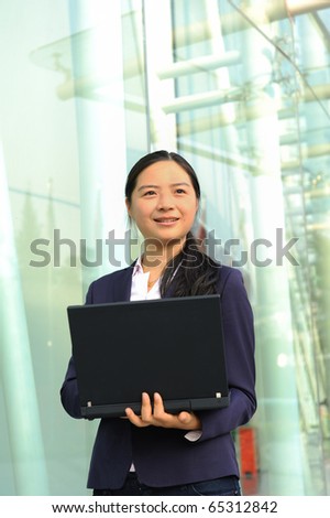beautiful asian business woman at office building with laptop computer