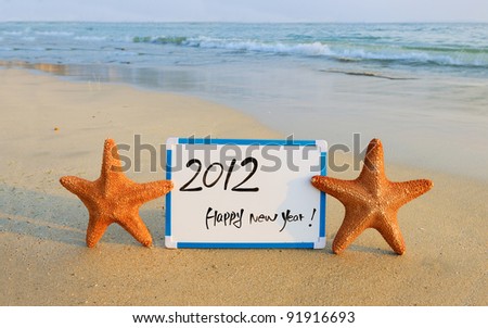 2012 happy new year message on the sand beach