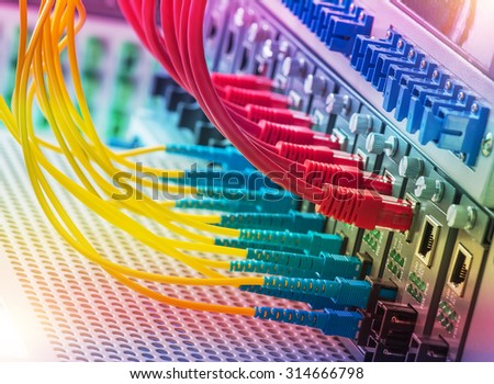 Fiber Optic cables connected to an optic ports and Network cables connected to ethernet ports.