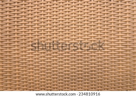 Detail of a light brown braiding of a chair made of plastic
