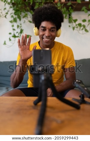 Similar – Image, Stock Photo Young man recording himself while playing guitar and singing to share the video in social media. Musician recording a music video at home.