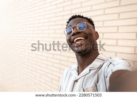 Similar – Foto Bild Junger Mann mit Sonnenbrille auf der Innenseite eines Maisfeldes