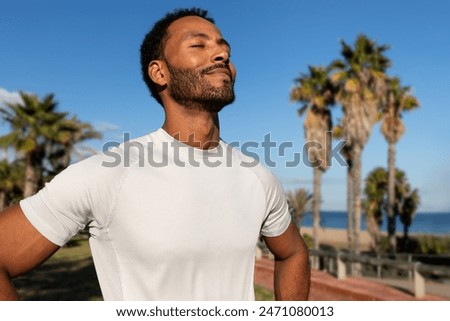 Similar – Image, Stock Photo Confident man exercising on cycling machine in gym