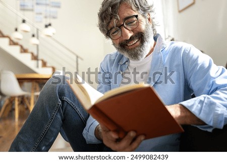 Similar – Image, Stock Photo Mature man reading book at home