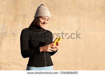 Image, Stock Photo Sportswoman using smartphone after training