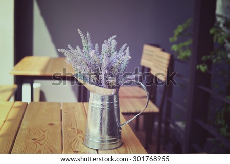 Vase of flowers on a table at cafe. Decoration coffee shop in vintage style