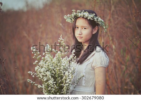 Pretty girl holding bouquet of white flowers. Portrait woman in vintage style