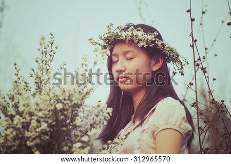 Pretty girl holding bouquet of white flowers. Portrait woman in Vintage style