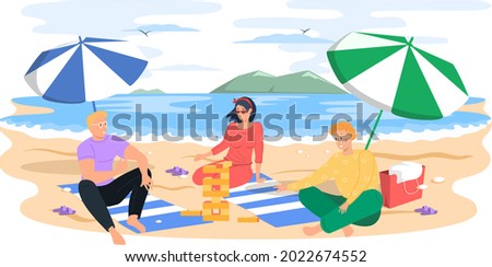 People relaxing on sun under beach umbrella with board game on vacation, sunbathing and playing jenga on sandy shore near water, summer fun. Friends enjoying rest by sea on weekend together 商業照片 © 