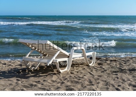 plastic sun lounger at the water's edge on the sandy beach of the Italian town of Lido Ostia, Italy Foto stock © 