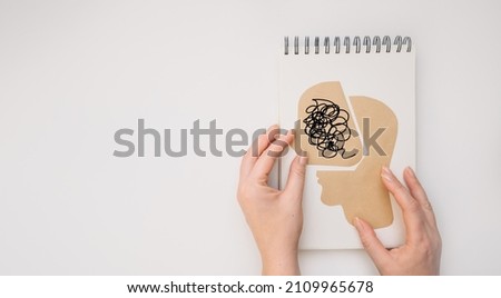 MENTAL HEALTH Mental Psychological Stress Management and Psychological trauma Health. Hand holding paper cut head on white background Сток-фото © 