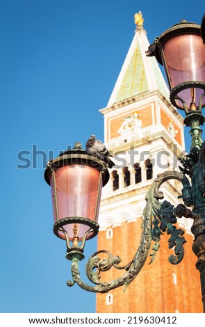 The lantern on San Marco Square, Venice. Pigeon sitting on lantern.