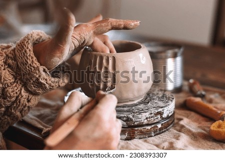 Similar – Image, Stock Photo Female ceramist making clay bowl in studio