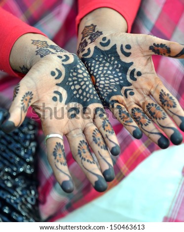African woman showing her hand tattoos