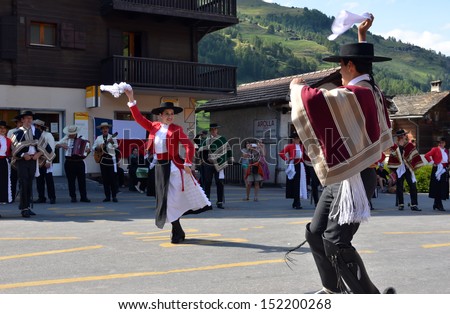 EVOLENE, SWITZERLAND - AUGUST 13: Chilean dance partners and orchestra at the International Festival of Folklore and Dance from the mountains (CIME) :  August 13, 2013 in Evolene Switzerland
