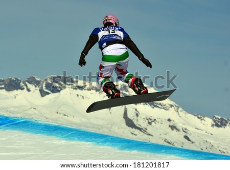 VEYSONNAZ, SWITZERLAND - MARCH 11: Rafaella BRUTTO (ITA) in the air in the Snowboard Cross World Cup: March 11, 2014 in Veysonnaz, Switzerland