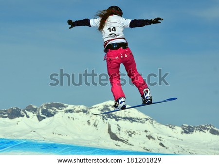 VEYSONNAZ, SWITZERLAND - MARCH 11: Chloe TRESPEUCH (FRA) takes to the air in the Snowboard Cross World Cup: March 11, 2014 in Veysonnaz, Switzerland