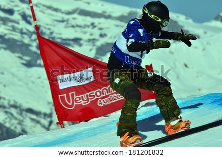 VEYSONNAZ, SWITZERLAND - MARCH 11: FUJIMORI (JPN) on a jump in the Snowboard Cross World Cup: March 11, 2014 in Veysonnaz, Switzerland