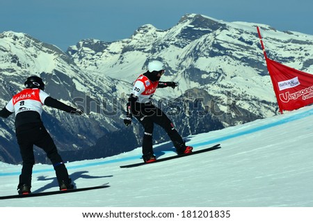 VEYSONNAZ, SWITZERLAND - MARCH 11: BERG leads SCHAD both germans in the Snowboard Cross World Cup: March 11, 2014 in Veysonnaz, Switzerland