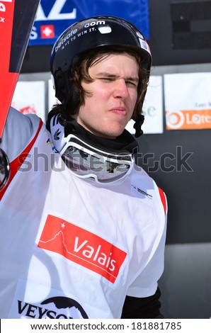 VEYSONNAZ, SWITZERLAND - MARCH 11: Anton LINDFORS (FIN) on the podium in the Snowboard Cross World Cup: March 11, 2014 in Veysonnaz, Switzerland